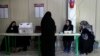 Staff members of a polling station attend to their stations during the parliamentary runoff elections in Tehran, Iran, May 10, 2024. I